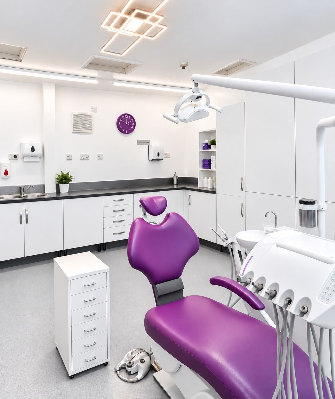 Modern dental treatment room with purple dental chair